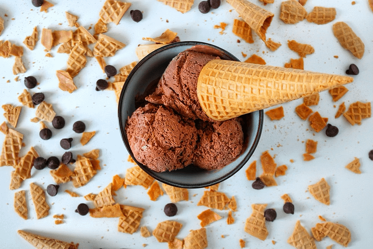 parve dairy-free chocolate ice cream with chocolate chips and sugar cone