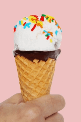 dairy-free vanilla ice cream with rainbow sprinkles and chocolate sugar cone