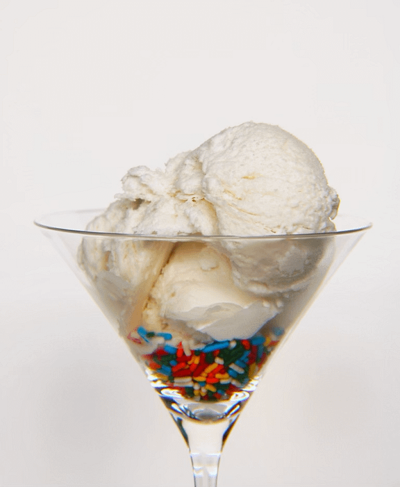 dairy-free vanilla ice cream with rainbow sprinkles in a martini glass